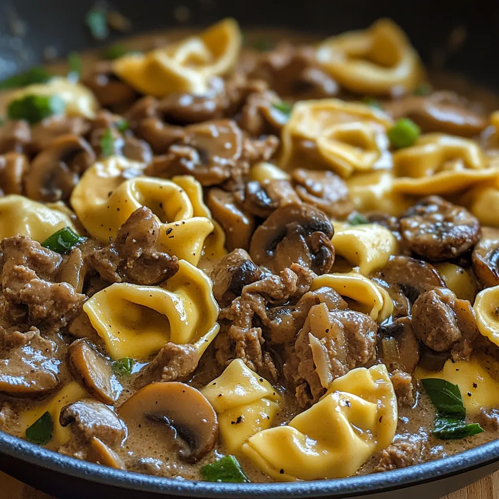 A bowl of pasta with meat and mushrooms.